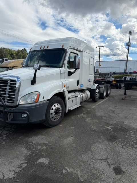 Flintstone Trucking white semi-truck parked outdoors